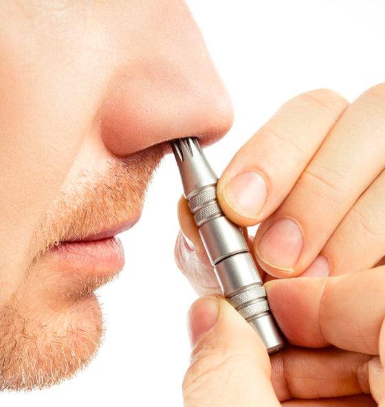 Mann nutzt mechanischen Nasenhaarschneider aus rostfreiem Stahl zur schmerzfreien Entfernung von Nasenhaaren ohne Batterien.
